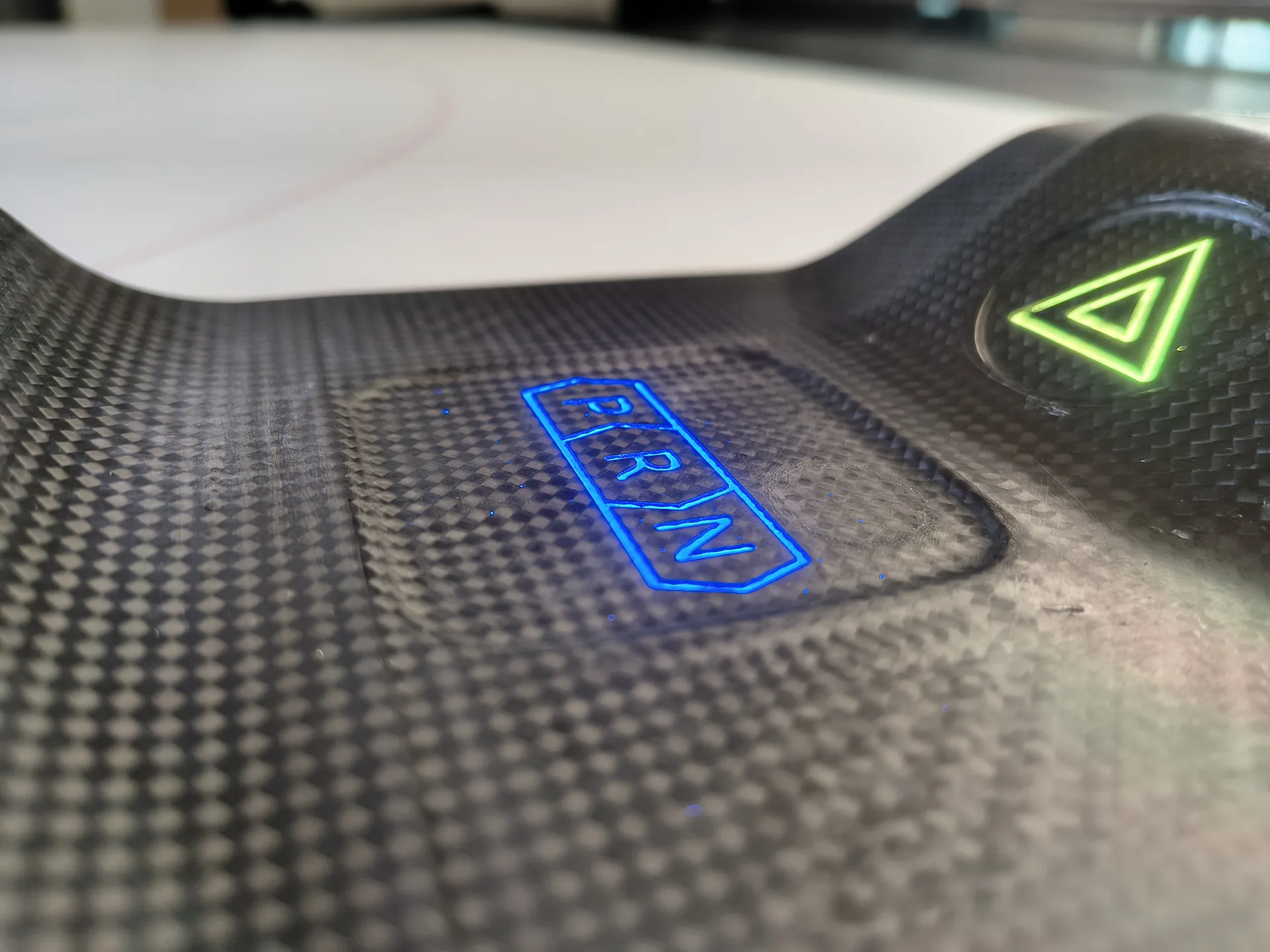 PRND capacitive interface integrated into curved carbon fiber structure