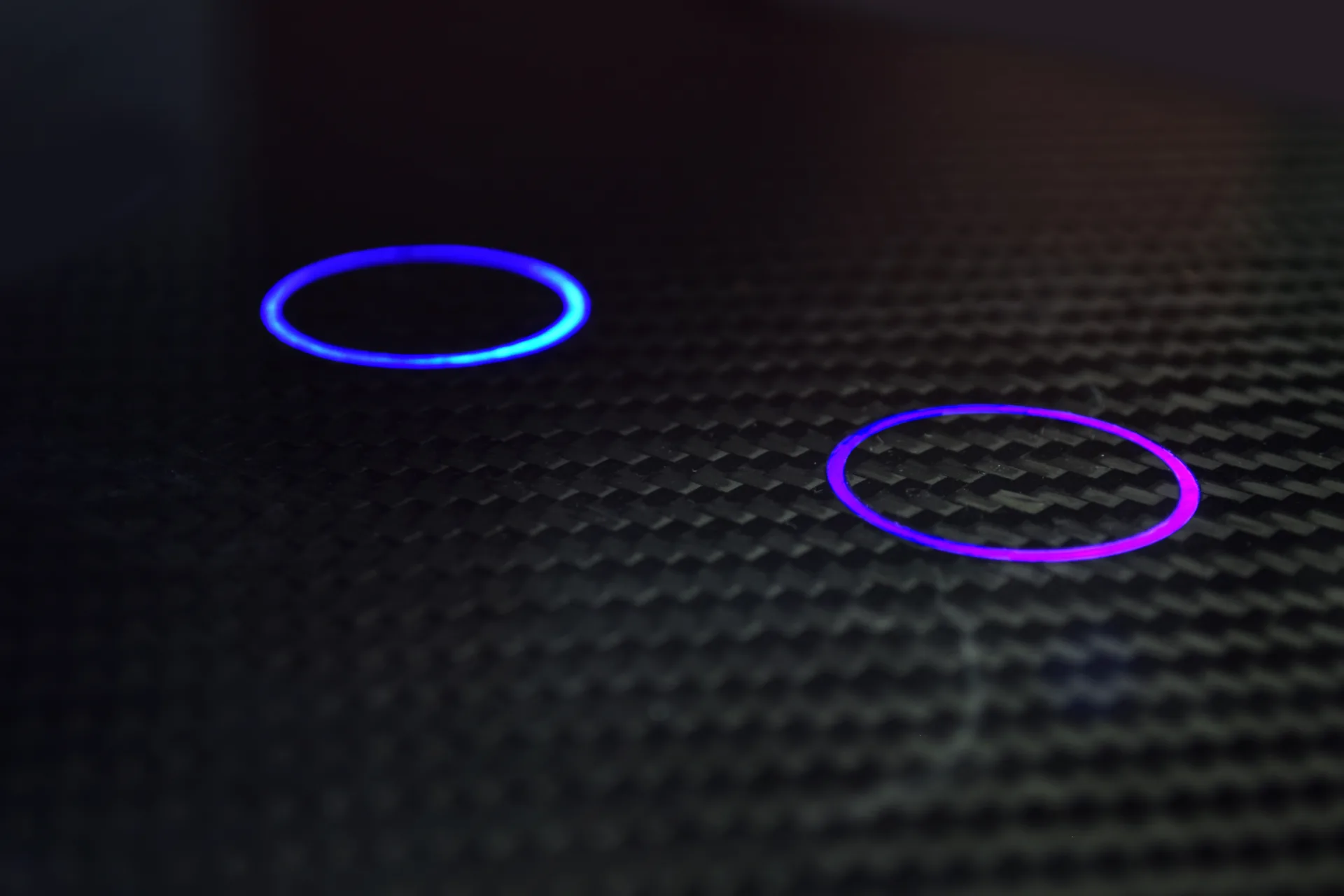 Dual circular touch zones integrated into carbon fiber texture