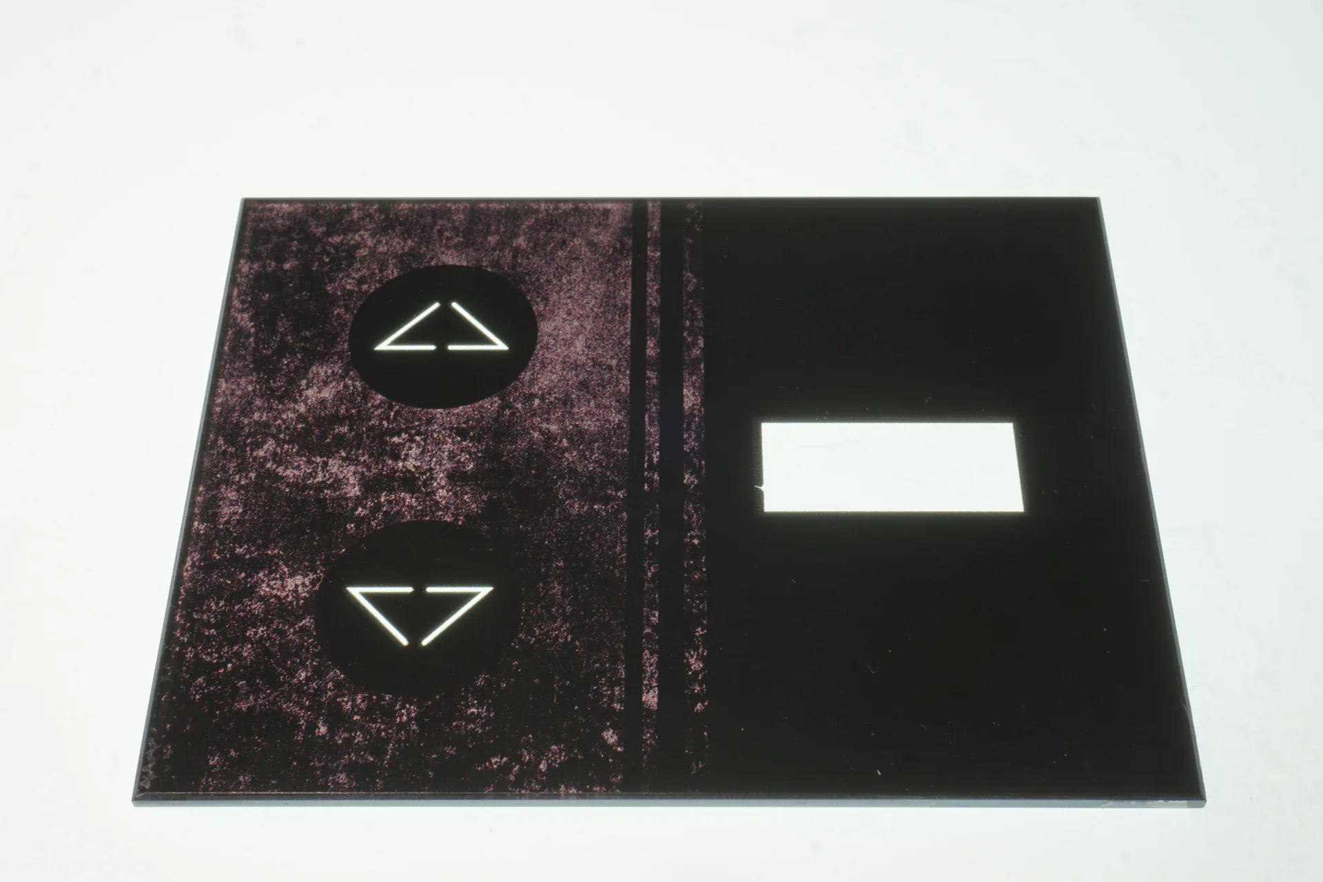 Dark textured glass control panel with backlit symbols